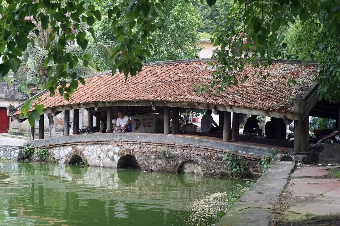 One of two bridege of Thay Pagoda, examples of house-on-bridge architecture design where a tiled-roof wooden structure rests atop the bridge span.
