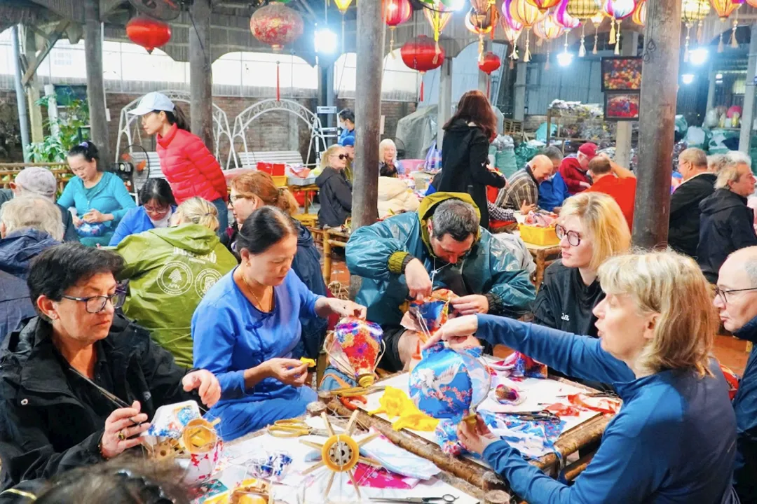 Tourists learn to make lanterns in Hoi An.