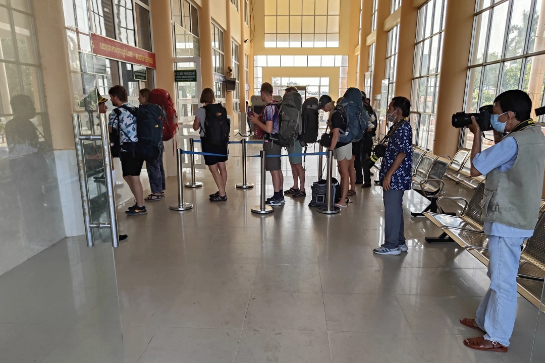 Tourists go through customs procedures at the border crossing.