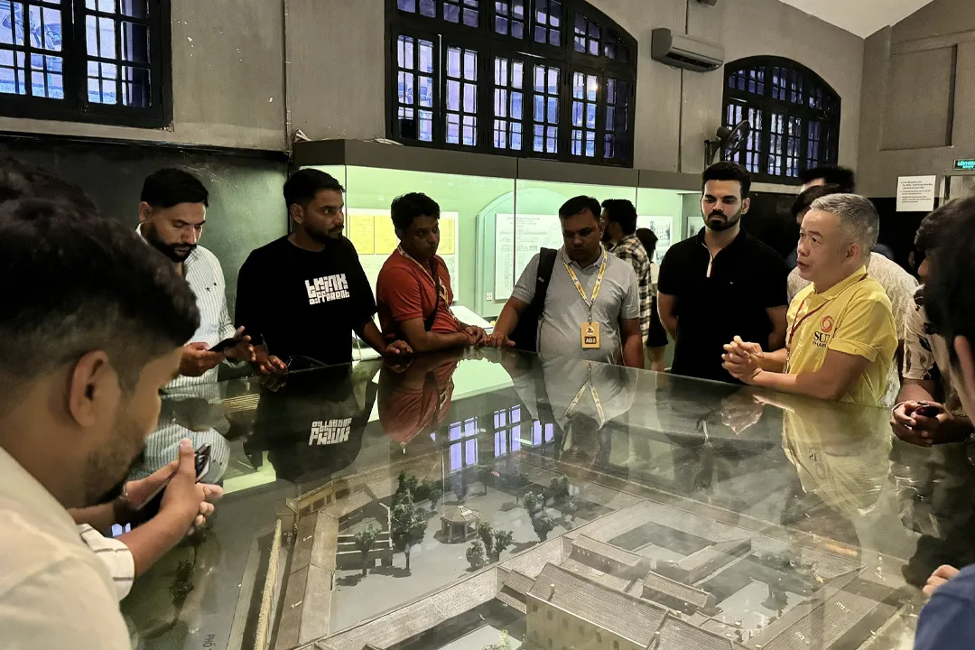 Tourists are listening to a guide about the prison