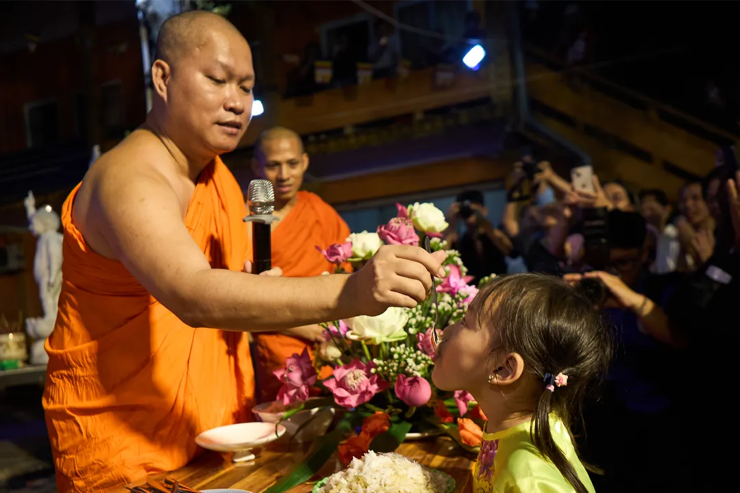 The "feeding of flattened green rice" ritual—an indispensable part of the festival