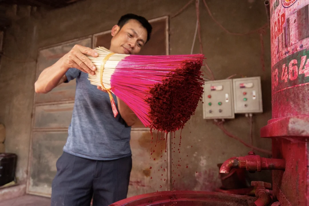 The sticks are dipped in vats of boiling dye