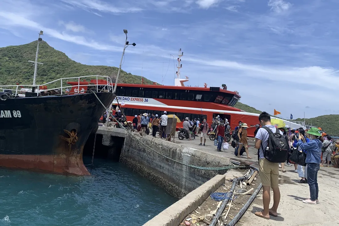 Tourists board the ship at Tran De port